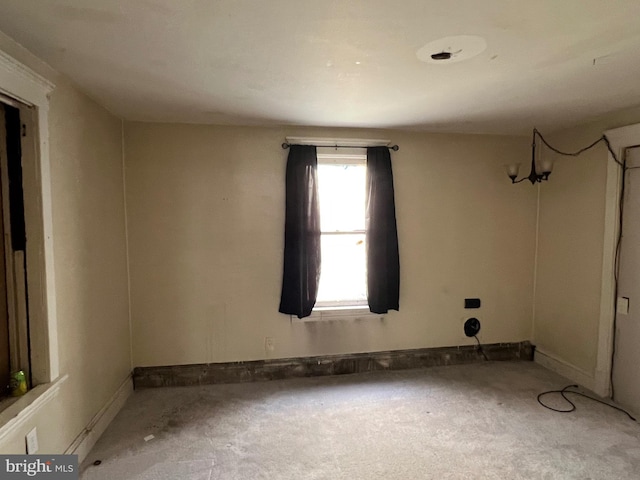 empty room with light carpet and baseboards