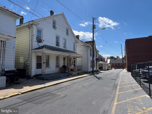 exterior space featuring curbs, street lighting, and sidewalks