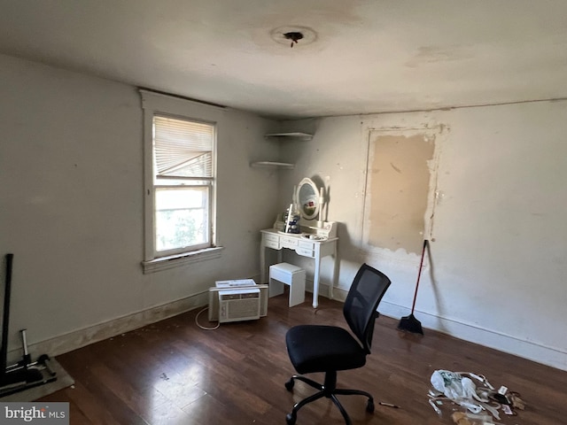home office featuring a wall mounted AC, baseboards, and wood finished floors