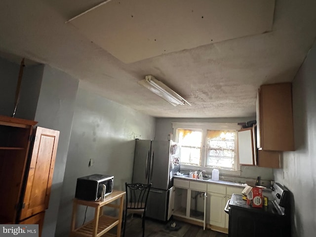 kitchen with light countertops, freestanding refrigerator, and electric range oven