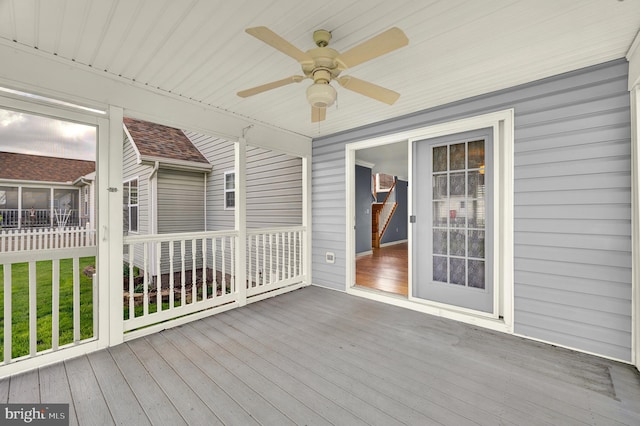 unfurnished sunroom with a ceiling fan