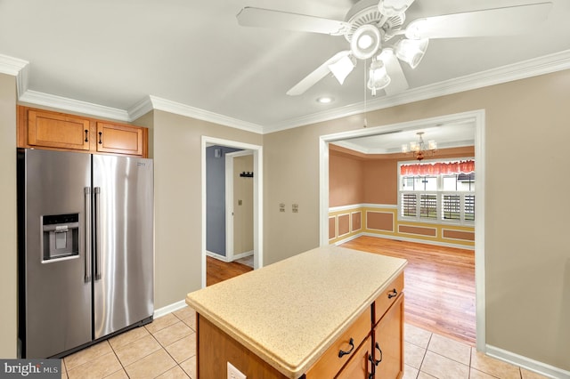 kitchen featuring ceiling fan with notable chandelier, stainless steel refrigerator with ice dispenser, light tile patterned flooring, and crown molding