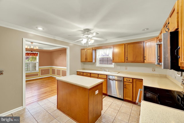 kitchen with stainless steel dishwasher, a center island, light tile patterned floors, light countertops, and ornamental molding