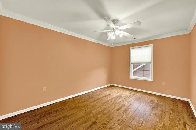 unfurnished room featuring wood finished floors, visible vents, ornamental molding, baseboards, and ceiling fan