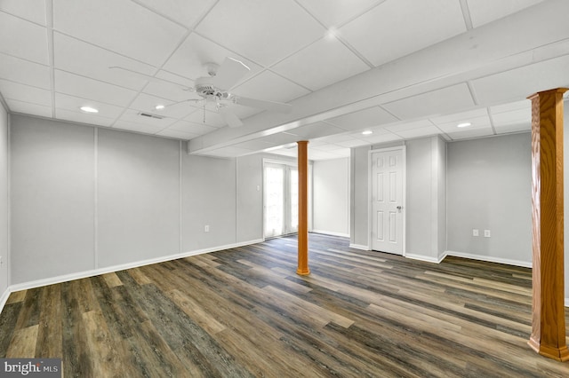below grade area with a paneled ceiling and wood finished floors