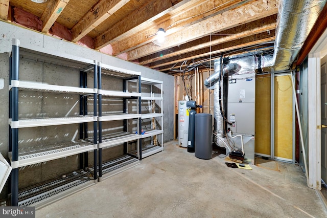 unfinished below grade area featuring heating unit and electric water heater