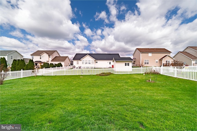 view of yard featuring a fenced backyard and a residential view