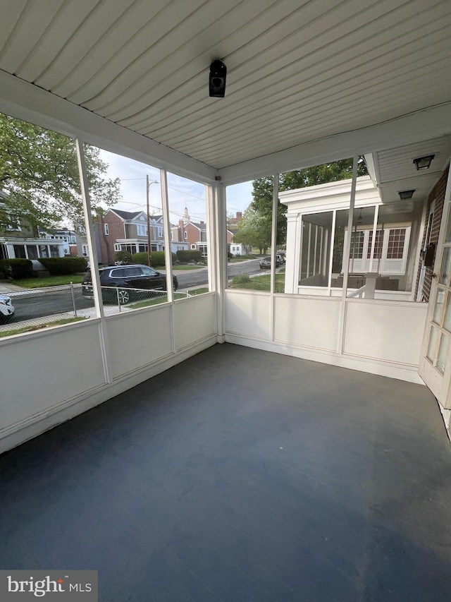 unfurnished sunroom featuring a residential view
