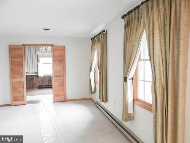 2560 Sardonyx Dr, Chambersburg, PA 17202 - spare room featuring a baseboard radiator, baseboards, and a healthy amount of sunlight