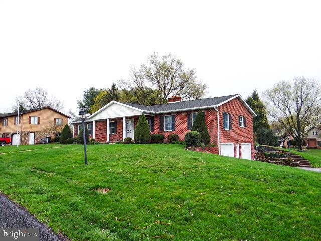 2560 Sardonyx Dr, Chambersburg, PA 17202 - single story home with brick siding, a front lawn, a garage, and a chimney