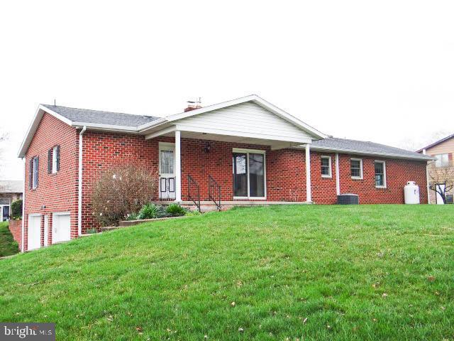 2560 Sardonyx Dr, Chambersburg, PA 17202 - rear view of house with a yard, a garage, and brick siding