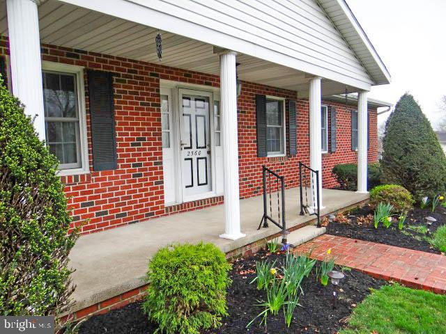 2560 Sardonyx Dr, Chambersburg, PA 17202 - entrance to property with covered porch and brick siding