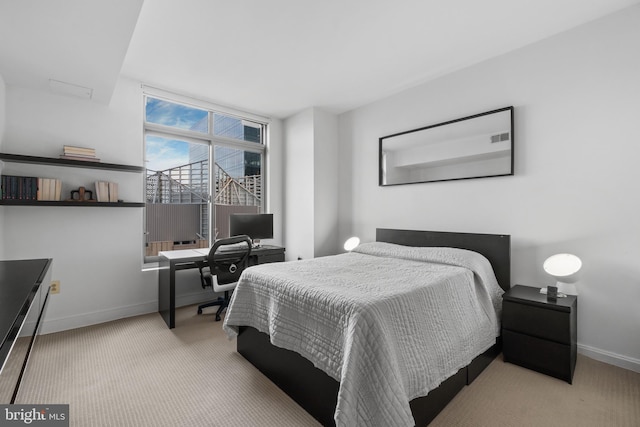 bedroom featuring baseboards, carpet flooring, and an office area