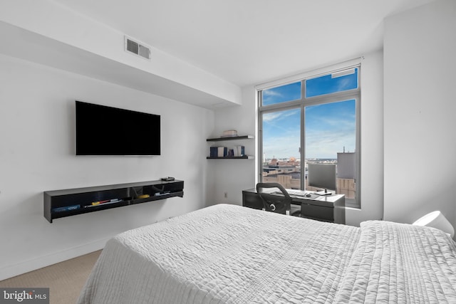 carpeted bedroom featuring baseboards