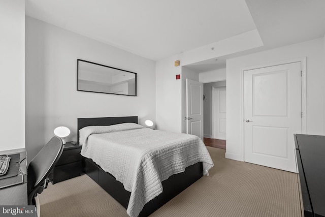 carpeted bedroom featuring a desk