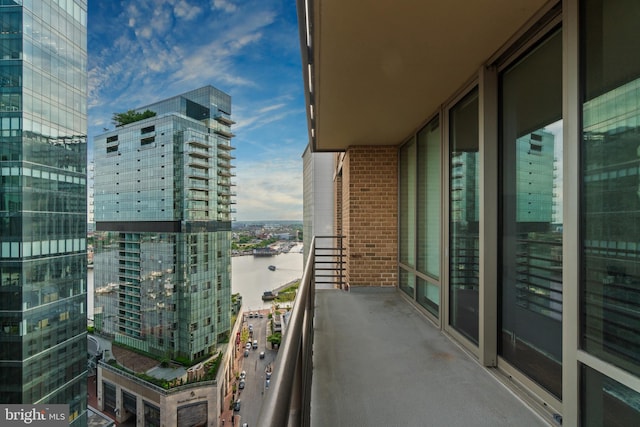 balcony with a water view and a city view
