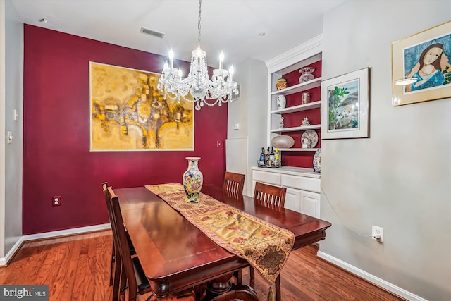 4129 Fountainside Ln Unit 202, Fairfax, VA 22030 - dining room featuring a chandelier, wood finished floors, baseboards, and built in shelves