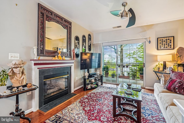 4129 Fountainside Ln Unit 202, Fairfax, VA 22030 - living area with ceiling fan, a fireplace with flush hearth, wood finished floors, and baseboards