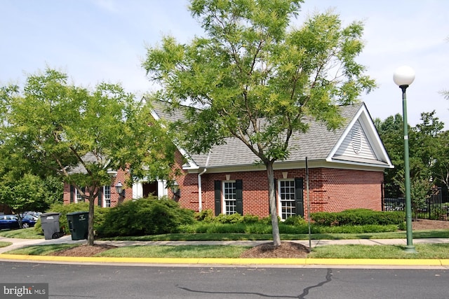 4129 Fountainside Ln Unit 202, Fairfax, VA 22030 - view of front facade featuring brick siding, roof with shingles, and fence