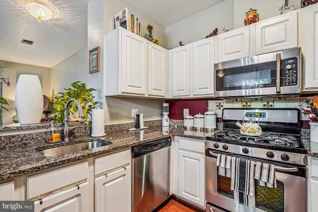 4129 Fountainside Ln Unit 202, Fairfax, VA 22030 - kitchen with appliances with stainless steel finishes, a sink, white cabinets, and dark stone countertops