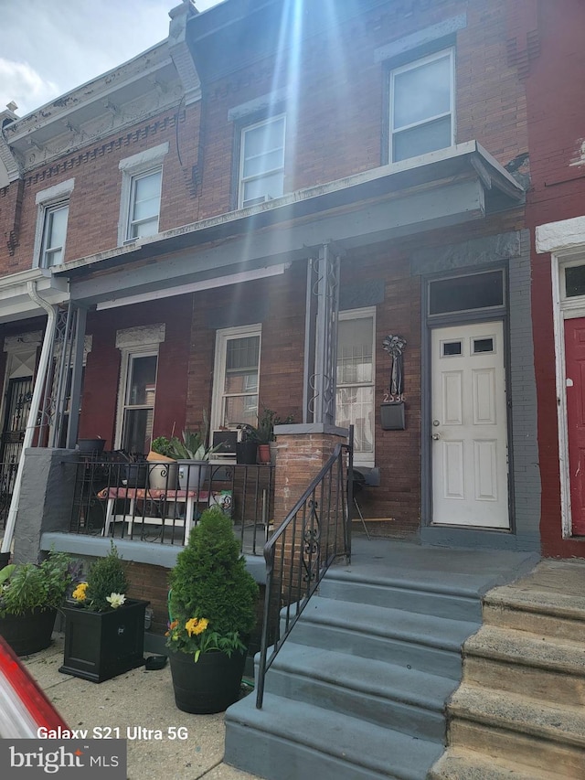 2536 N Myrtlewood St, Philadelphia, PA 19132 - view of front facade with brick siding and covered porch