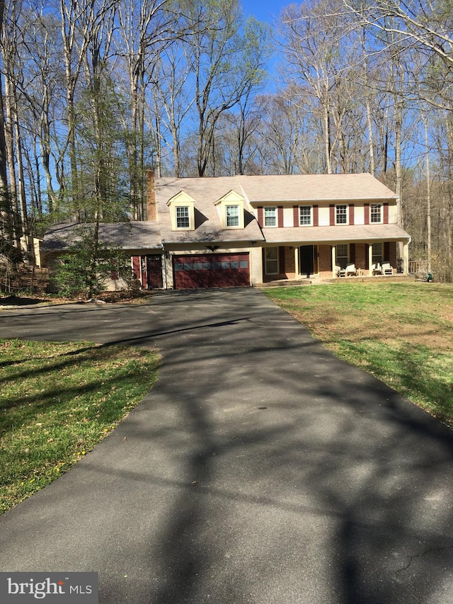 14452 Alps Dr, Woodbridge, VA 22193 - view of front of property featuring a porch, a front yard, and aphalt driveway