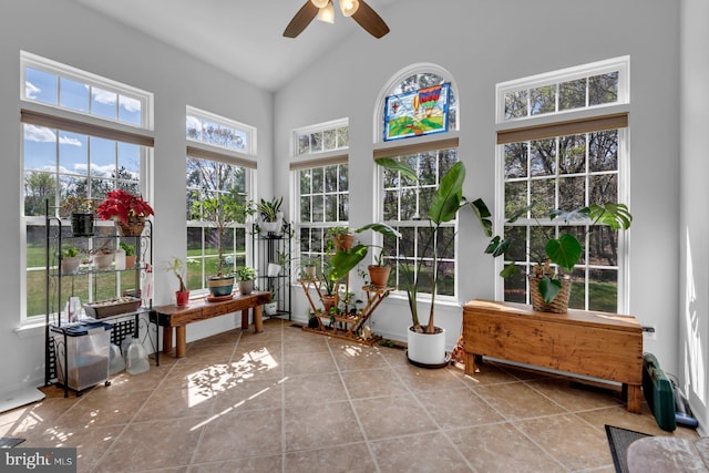 sunroom featuring tile patterned floors and high vaulted ceiling