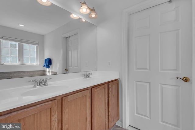 full bath featuring a sink and double vanity