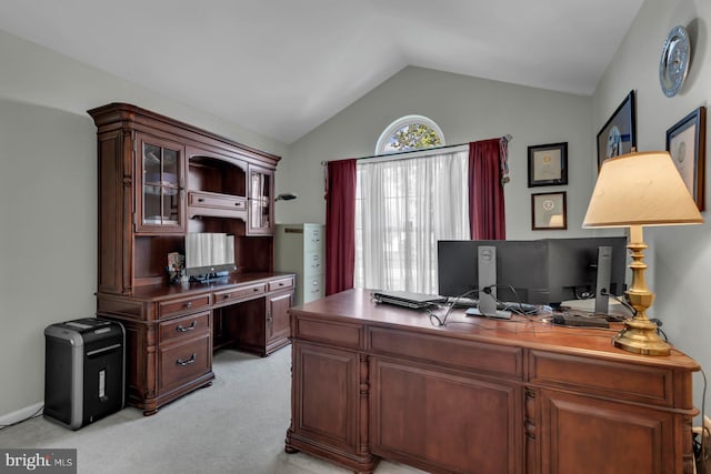 office area featuring light colored carpet and lofted ceiling