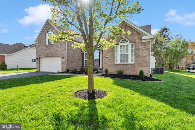 traditional-style house with a garage, central air condition unit, aphalt driveway, a front yard, and brick siding
