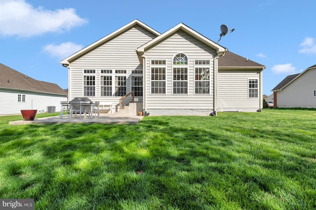 rear view of property with a patio area, entry steps, a yard, and central AC unit