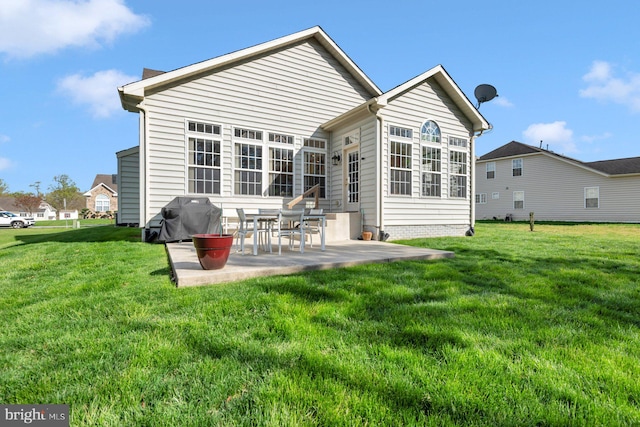 rear view of house featuring a patio area and a yard
