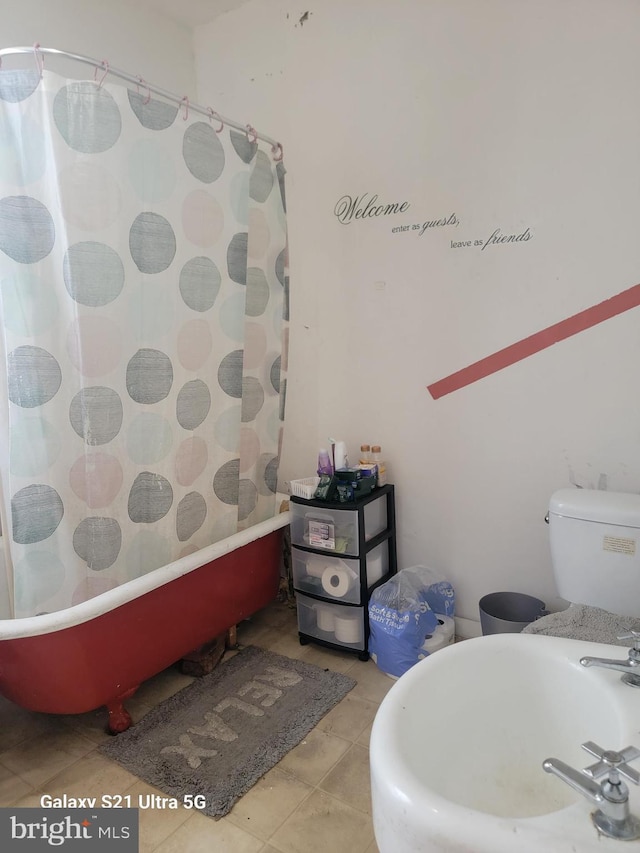 2538 N Myrtlewood St, Philadelphia, PA 19132 - bathroom featuring a shower with shower curtain, tile patterned floors, a bathtub, toilet, and a sink