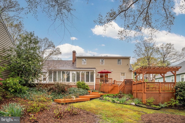 135 Cleremont Dr, Fredericksburg, VA 22405 - back of house with a deck, a sunroom, a pergola, a yard, and a chimney