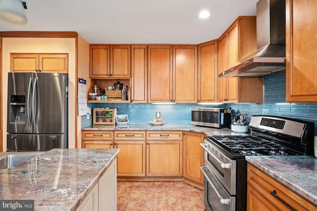 135 Cleremont Dr, Fredericksburg, VA 22405 - kitchen featuring light stone counters, decorative backsplash, wall chimney range hood, and stainless steel appliances