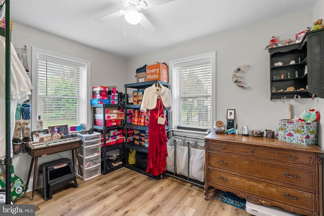 interior space featuring light wood-style flooring and a ceiling fan