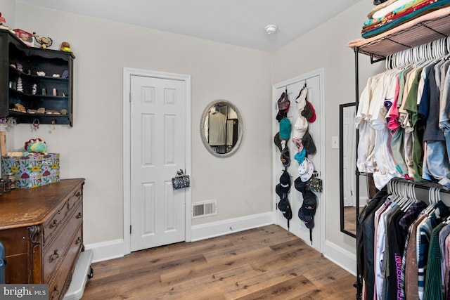 interior space with visible vents and wood finished floors