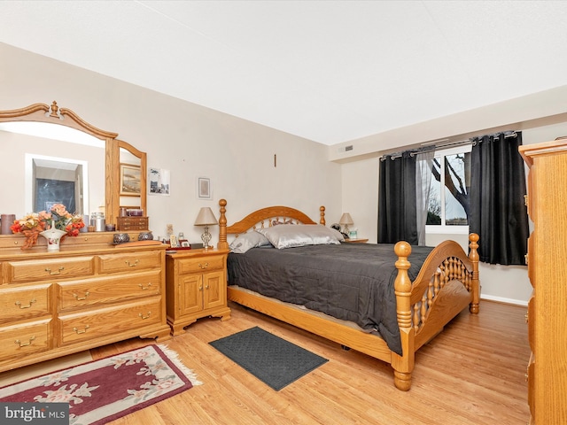 bedroom featuring light wood-style flooring and visible vents