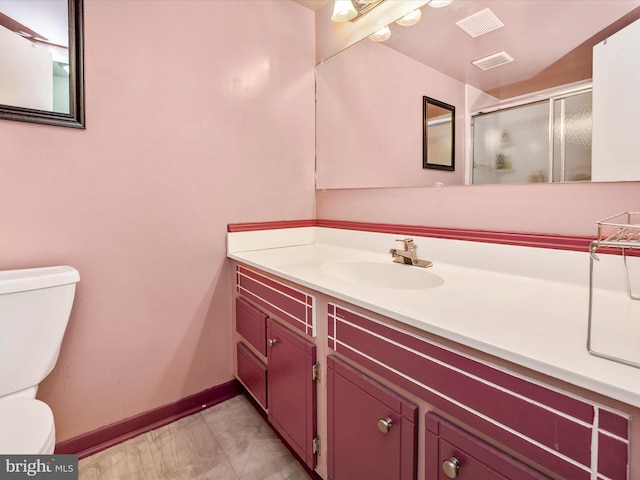 bathroom featuring a stall shower, visible vents, baseboards, and toilet