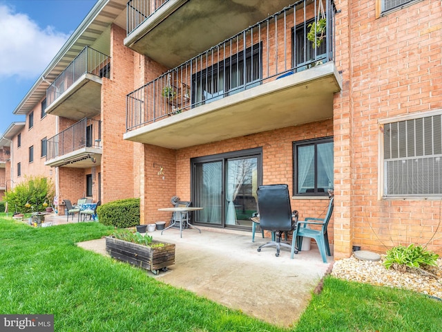 exterior space featuring a patio and a lawn