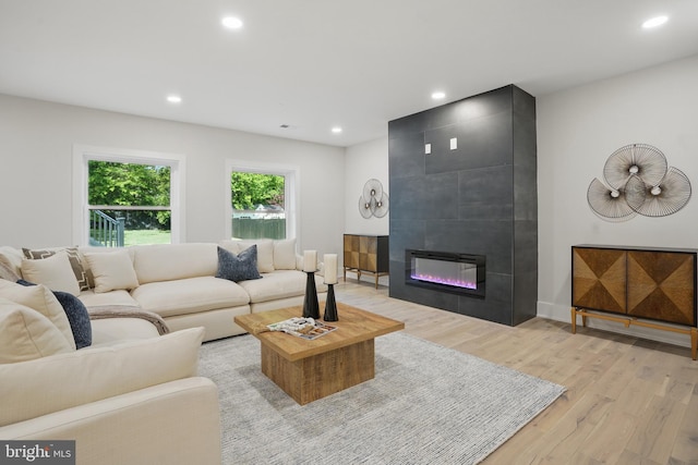 4134 Maple Ave, Fairfax, VA 22032 - living area with recessed lighting, a large fireplace, and light wood-style floors