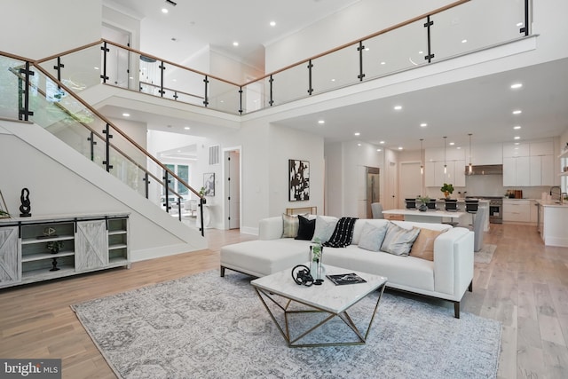 4134 Maple Ave, Fairfax, VA 22032 - living room with stairway, a high ceiling, light wood-style floors, and visible vents