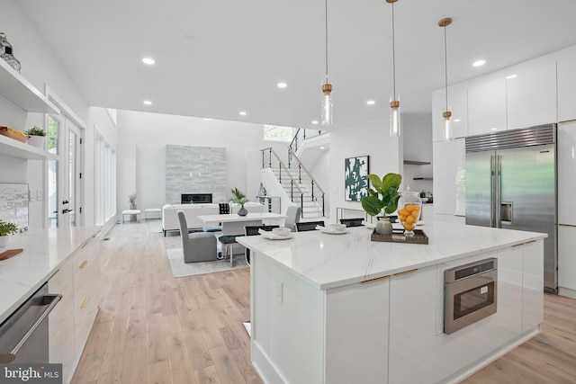 4134 Maple Ave, Fairfax, VA 22032 - kitchen with light wood-style flooring, white cabinetry, modern cabinets, and stainless steel appliances