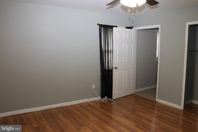 unfurnished bedroom with ceiling fan, baseboards, and wood finished floors