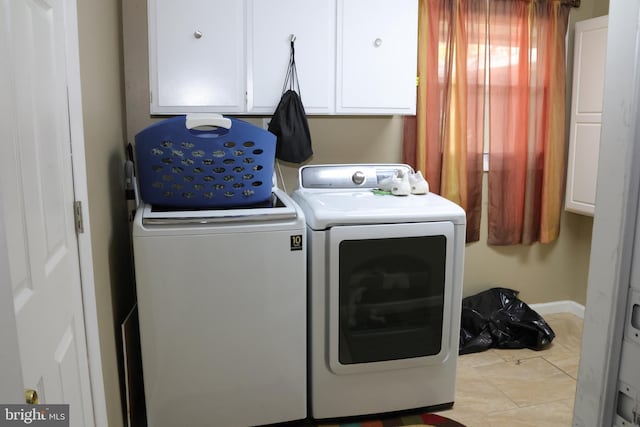 laundry room featuring cabinet space, washing machine and dryer, and baseboards