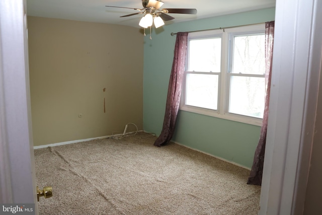 spare room with baseboards, carpet, and ceiling fan