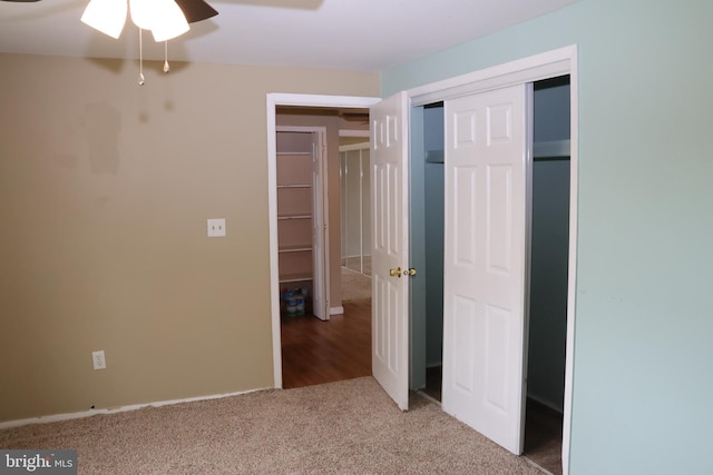 unfurnished bedroom featuring ceiling fan, carpet floors, and a closet