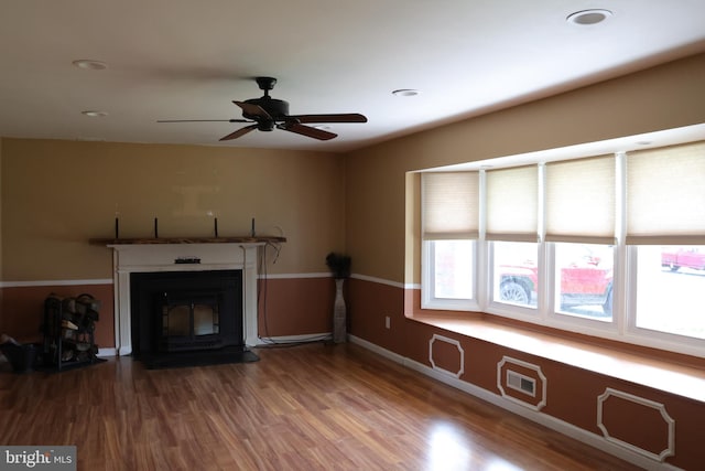 unfurnished living room with a ceiling fan, wood finished floors, a fireplace, and recessed lighting