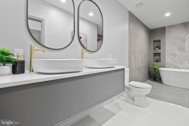 325 Gilmor St, Baltimore, MD 21223 - bathroom with tile walls, visible vents, recessed lighting, and a freestanding bath