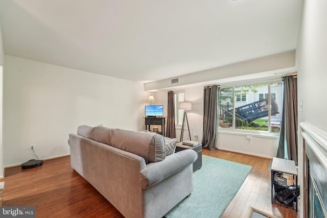 living room featuring baseboards and wood finished floors